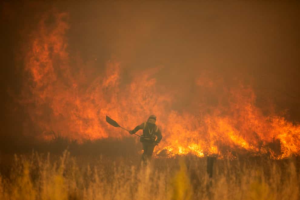 A firefighter works in front of flames during a wildfire in the Sierra de la Culebra in the Zamora Provence of Spain (AP)