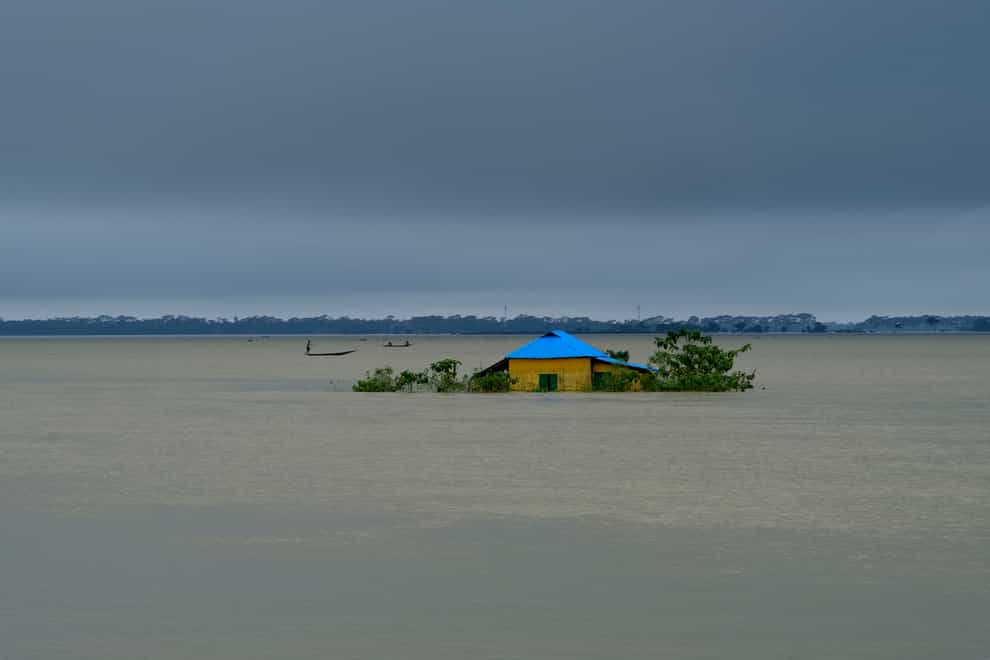 A house stands surrounded by floodwaters in Sylhet, Bangladesh, on Monday, June 20 2022 (Mahmud Hossain Opu/AP)