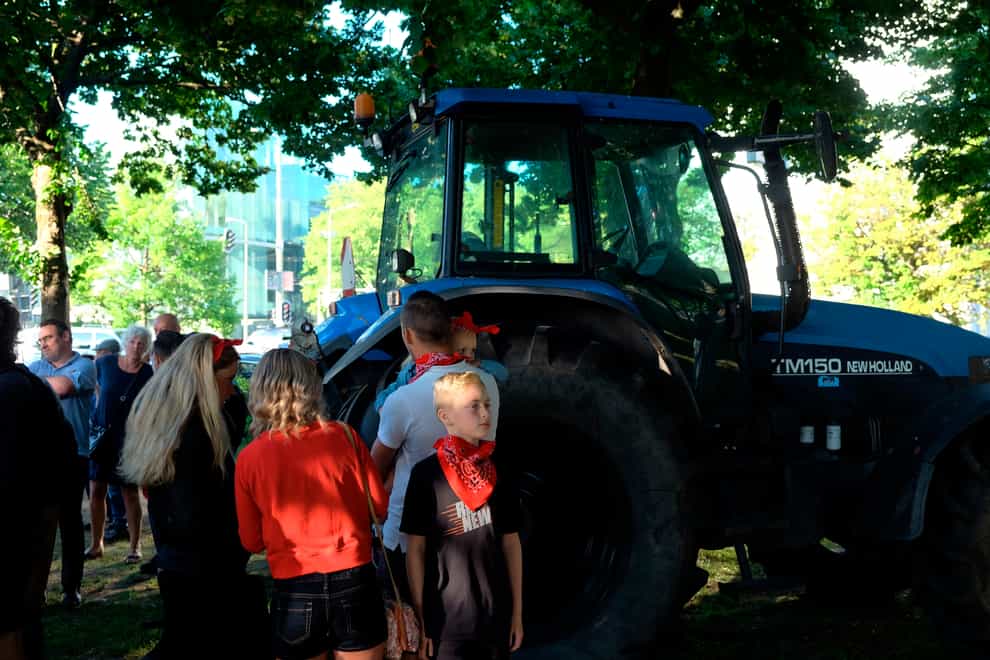 A small group of people gather ahead of a major protest by farmers at a village in central Netherlands, in The Hague, Netherlands (Michael Corder/AP)