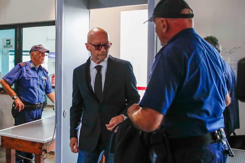 Canadian-born film director Paul Haggis, centre, arrives at the Brindisi law court in southern Italy on Wednesday June 22 2022 (Salvatore Laporta/AP)