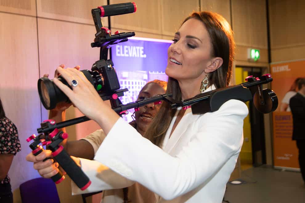The Duchess of Cambridge holds a camera (Eddie Mulholland/PA)