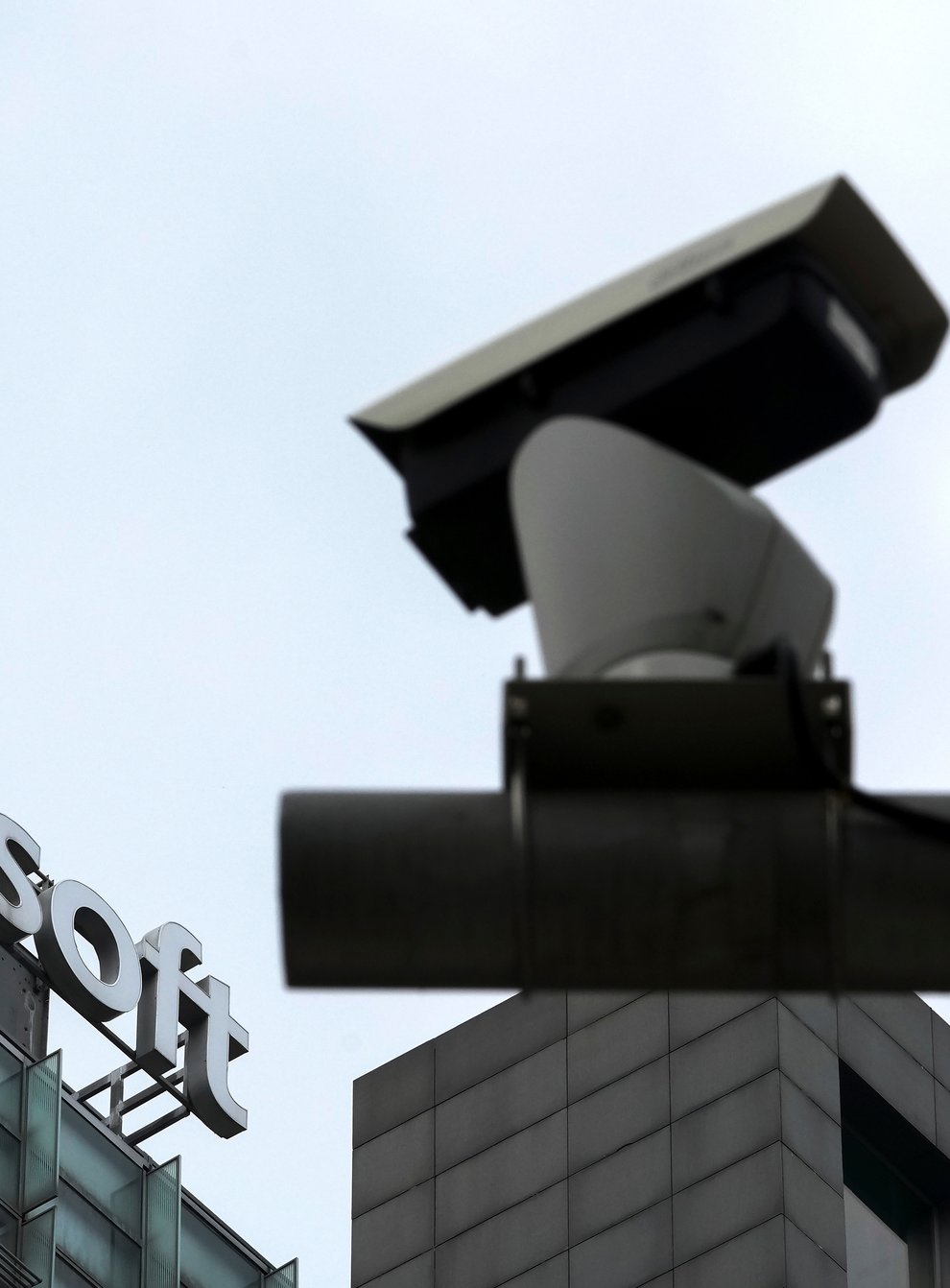 A security surveillance camera is seen near the Microsoft office building in Beijing (Andy Wong/AP)