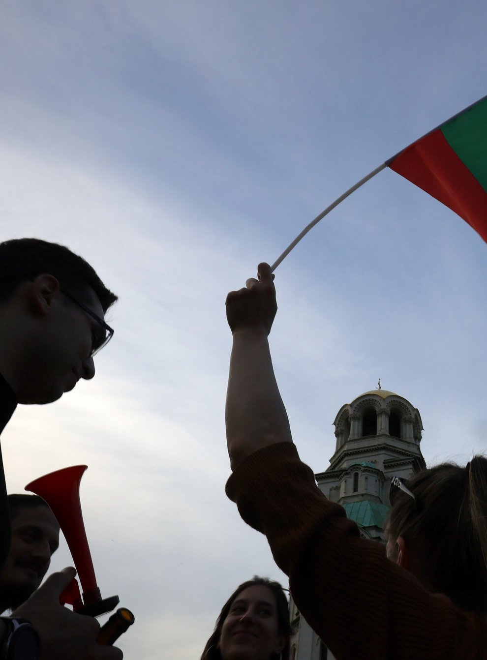 A pro-government protester holds a Bulgarian flag (Valentina Petrova/AP)