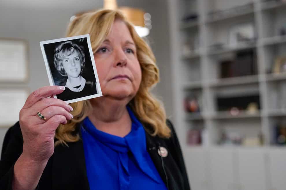 Nassau County district attorney Anne Donnelly holds a photo of Diane Cusick during an interview with The Associated Press (Mary Altaffer/AP)