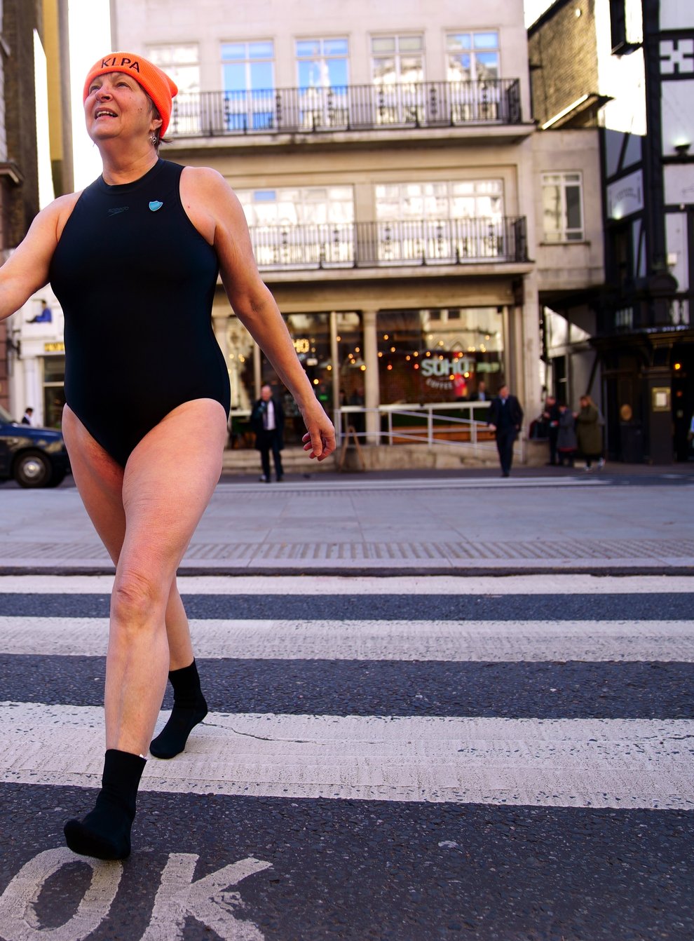 A swimmer from Hampstead Ponds crosses the road outside the Royal Courts of Justice, London (Victoria Jones/PA)