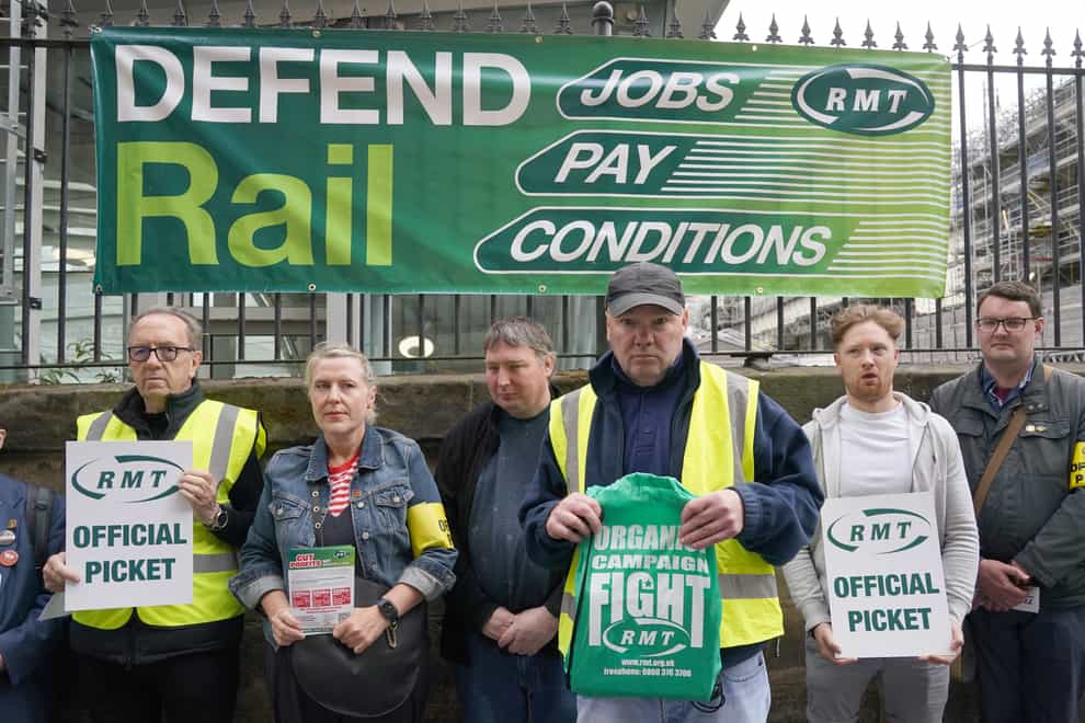 Members of the RMT picket at the entrance to Waverley Station in Edinburgh (Andrew Milligan/PA)
