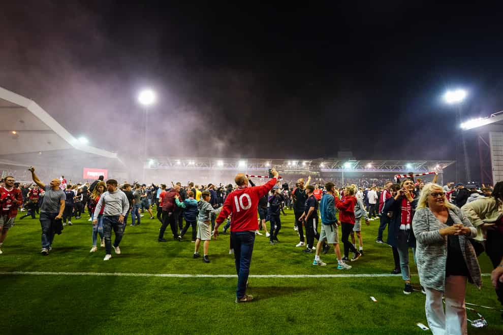 Nottingham Forest fans celebrate on the pitch after they reach the play off final during the Sky Bet Championship play-off semi-final, second leg match at the City Ground, Nottingham (Zac Goodwin/PA)