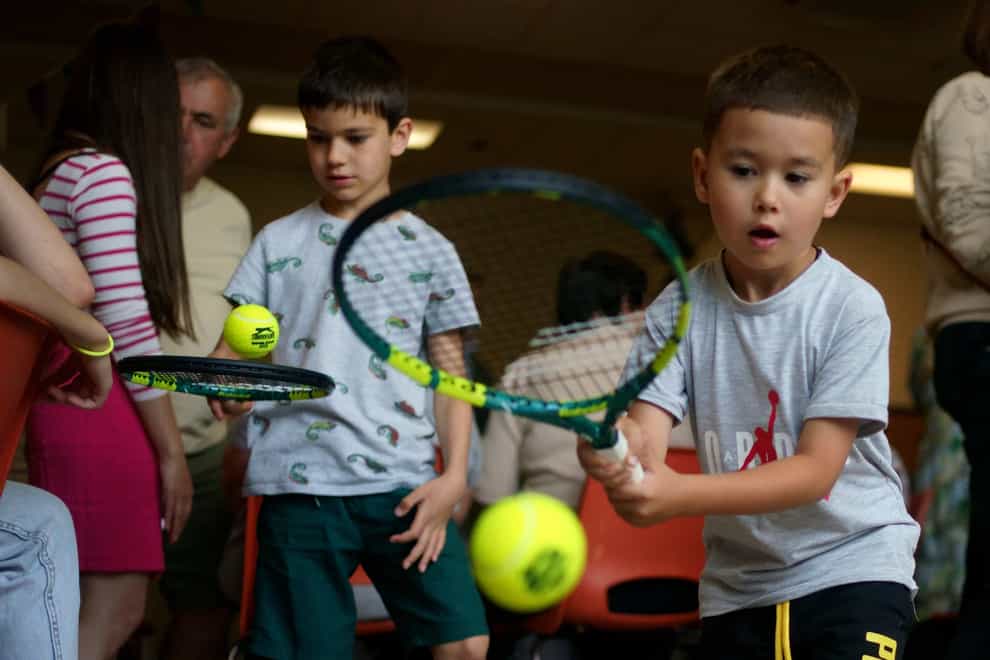 Seven-year-old Makar Hovorukha and Matvii Pysarchuk, aged five, attend a Wimbledon-themed afternoon tea (Victoria Jones/PA)