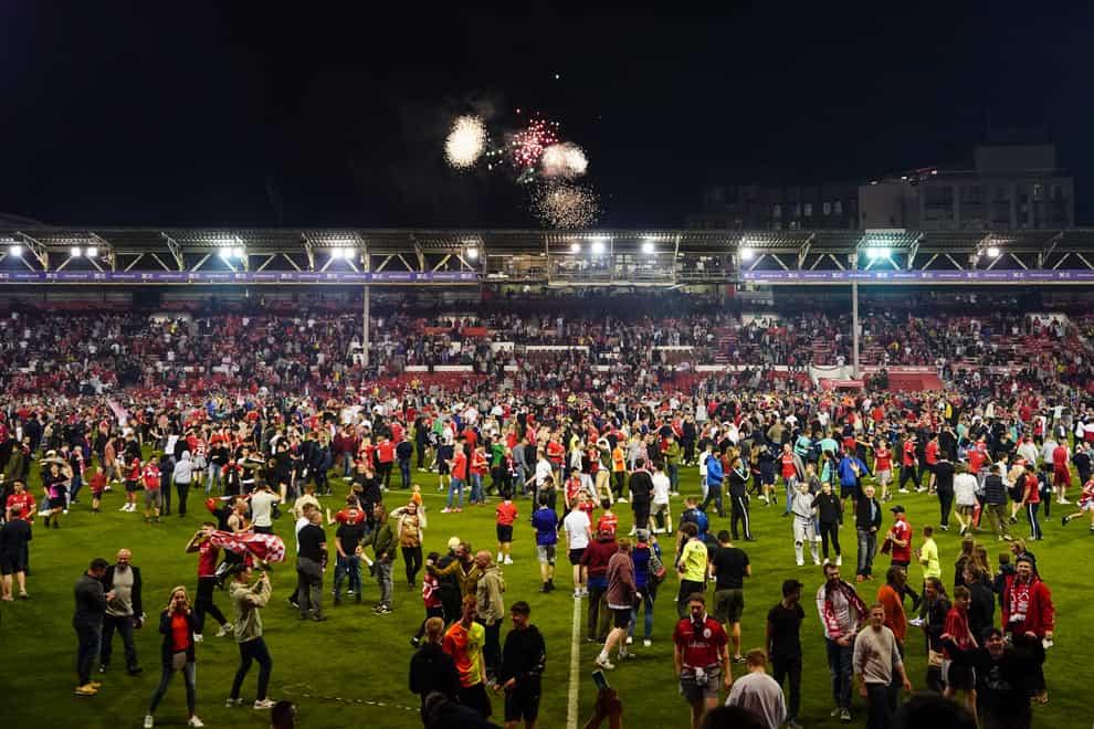 Nottingham Forest fans celebrate on the pitch after they reached the play off final (Zac Goodwin/PA)