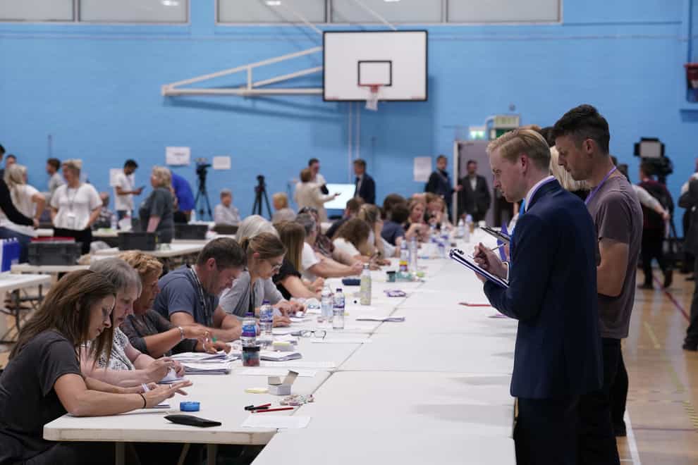 Postal votes are counted at the Lords Meadow Leisure Centre, in Crediton, Devon, for the Tiverton and Honiton by-election, which was triggered by the resignation of MP Neil Parish for watching pornography in the Commons. Picture date: Thursday June 23, 2022.