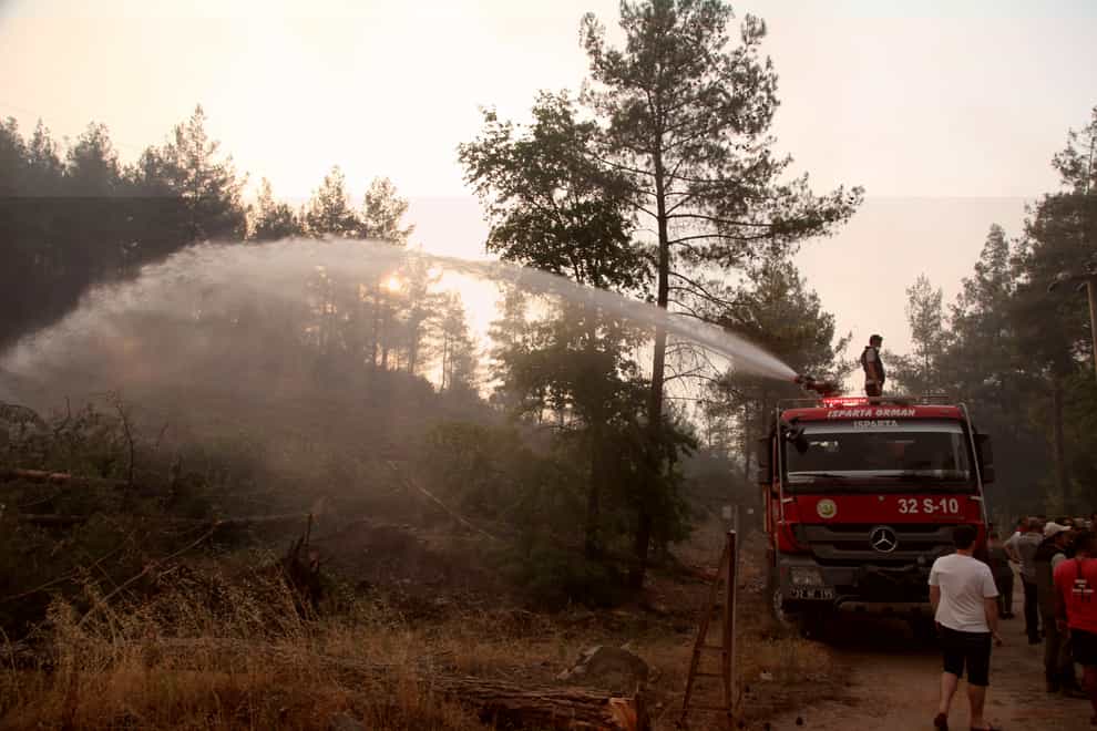 Firefighters work to extinguish a fire in the Bordubet region (AP)