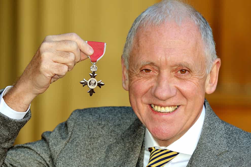 Harry Gration holding his MBE presented to him by the Prince of Wales (John Stillwell/PA)
