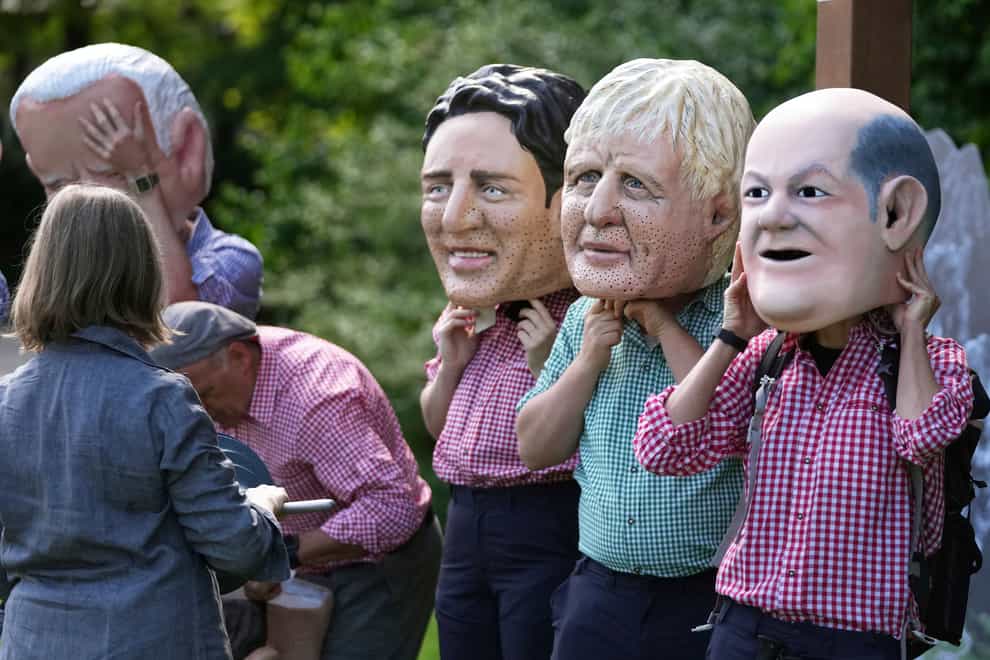 Activists from Oxfam wear giant heads depicting G7 leaders during a demonstration in Munich, Germany (Matthias Schrader/AP)