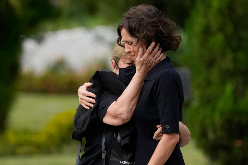 Alessandra Sampaio, right, is comforted during the funeral of her husband British journalist Dom Phillips (Silvia Izquierdo/AP)