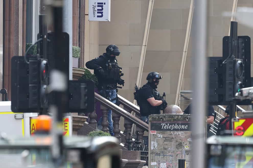 Armed police officers leave the Park Inn hotel in West George Street, Glasgow in June 2020 (Andrew Milligan/PA)