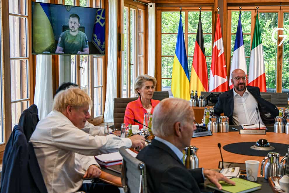 From left, Britain’s Prime Minister Boris Johnson, Japan’s Prime Minister Fumio Kishida, European Commission President Ursula von der Leyen, US President Joe Biden, European Council President Charles Michel before a round table as Ukraine President Volodymyr Zelenskyy appears on screen to address the G7 leaders via video link during their working session at Castle Elmau in Kruen, near Garmisch-Partenkirchen, Germany, on Monday, June 27, 2022. The Group of Seven leading economic powers are meeting in Germany for their annual gathering Sunday through Tuesday. (Kenny Holston/Pool via AP)