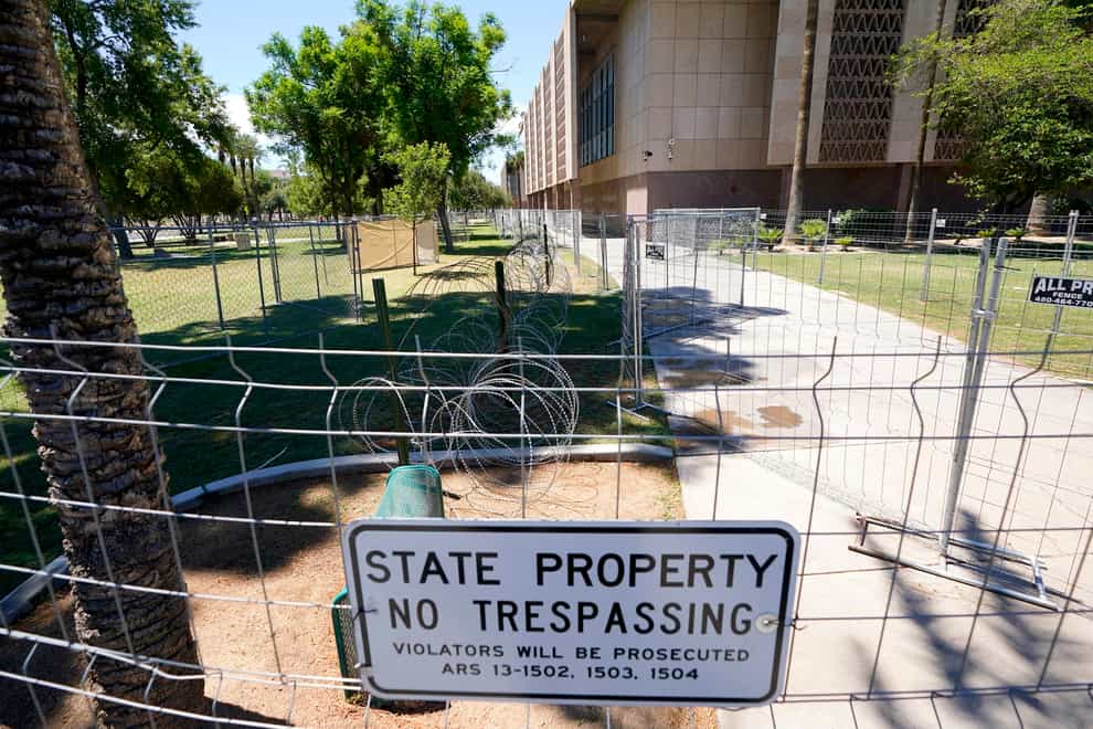 After multiple nights of abortion-rights protests, security fences and barbed wire surround the Arizona Capitol (Ross D Franklin/AP)