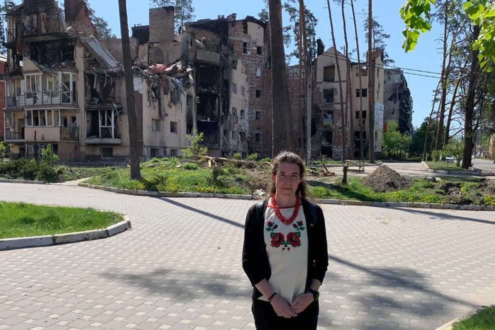 Welsh diplomat Kate Davenport, who is based in Ukraine, outside a bombed building in Irpin (Foreign, Commonwealth and Development Office/PA)