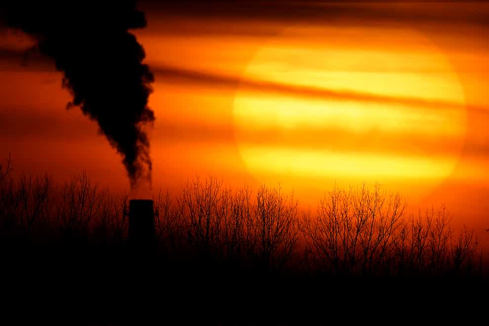 A coal-fired power plant is silhouetted against the setting sun in Kansas (AP)