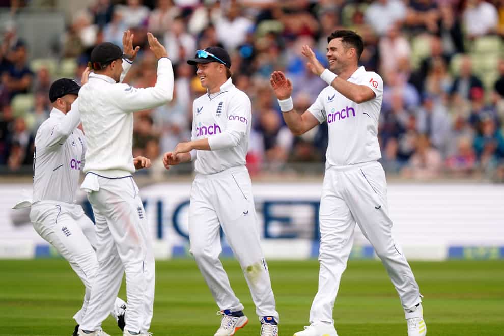 England’s James Anderson (right) celebrates taking the wicket of Cheteshwar Pujara (Mike Egerton/PA)