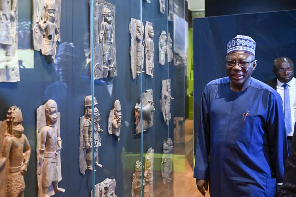 Abba Tijani, director general of the National Museums and Monuments Authority of Nigeria, with Benin Bronzes at the Linden Museum in Stuttgart, Germany (Bernd Weissbrod/dpa/AP)