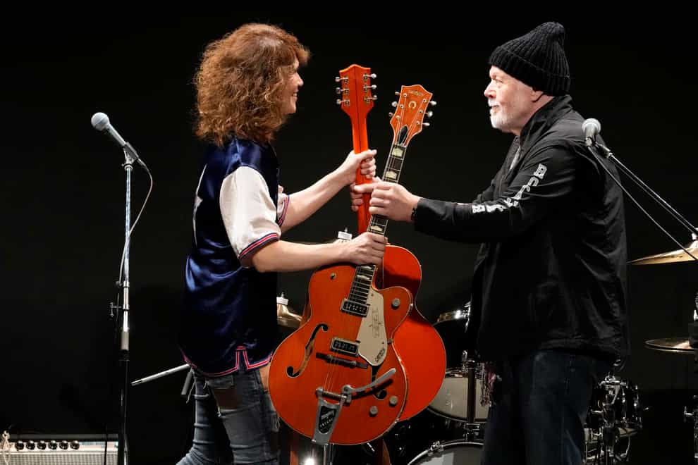 Canadian rock legend Randy Bachman, right, receives his Gretsch guitar (Eugene Hoshiko/AP)