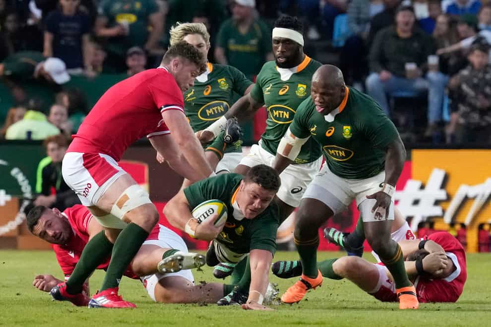 South Africa’s Jasper Wiese, bottom, falls on the ground as Wales’ Will Rowlands, left, defends during the Rugby Championship test match between South Africa and Wales at Loftus Versfeld Stadium in Pretoria, South Africa, Saturday, July 2, 2022. (AP Photo/Themba Hadebe)