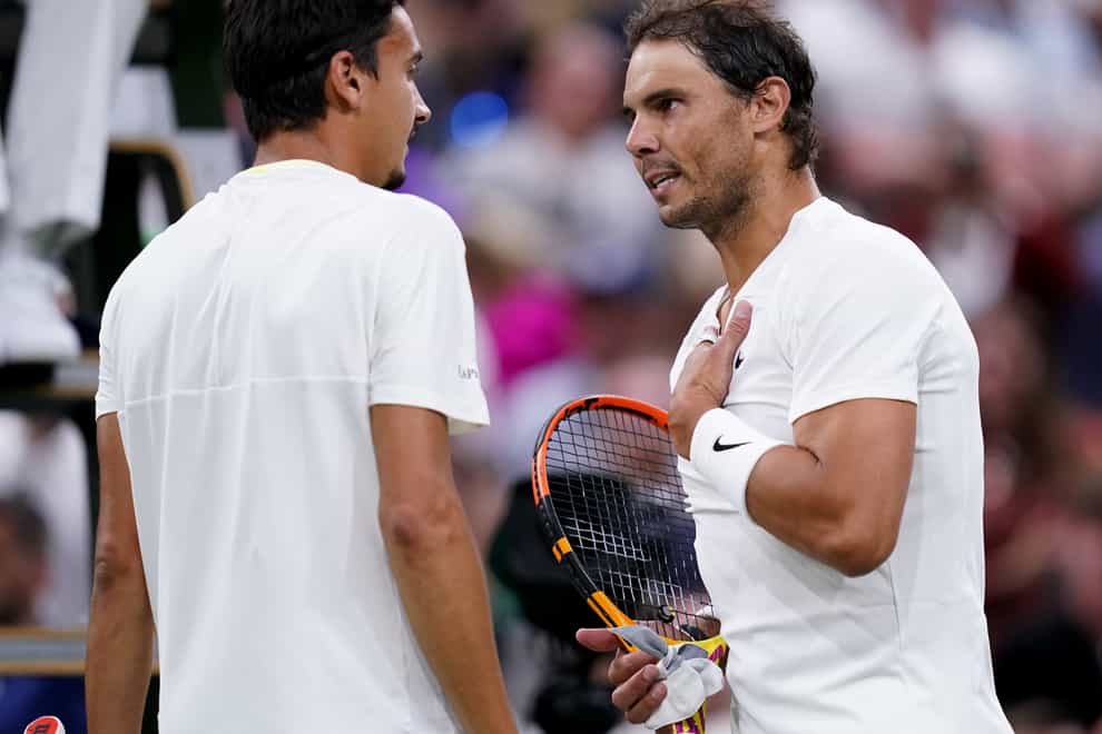 Rafael Nadal and Lorenzo Sonego speak at the net (John Walton/PA)
