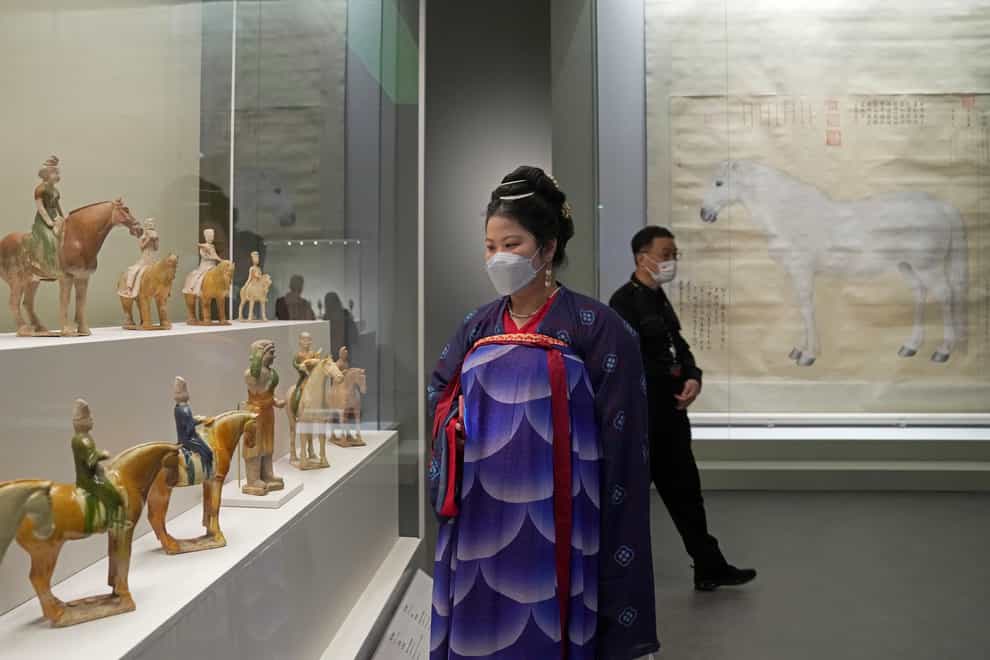 A visitor dressed in Chinese costume tours the Hong Kong Palace Museum (Kin Cheung/AP)