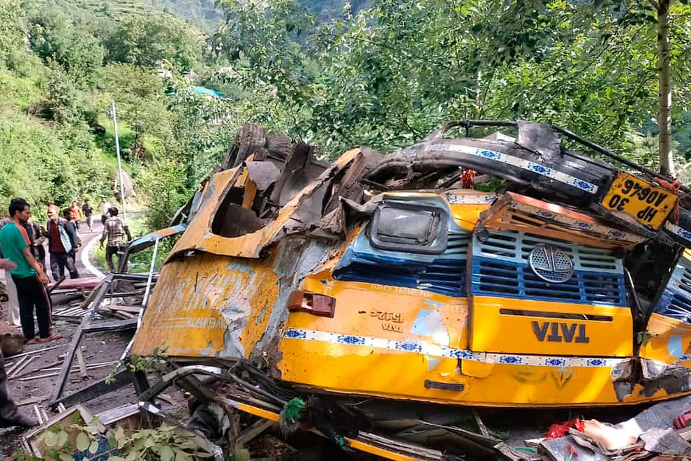 The wreckage of a passenger that bus slid off a mountain road and fell into a deep gorge near Kullu, Himachal Pradesh state, India (Deputy Commissioner’s office/AP)
