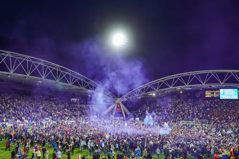 Huddersfield fans invaded the pitch after their play-off win against Luton (Tim Goode/PA)
