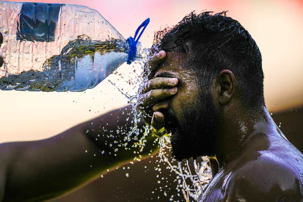 A wrestler cools off as he competes during the 661st annual Historic Kirkpinar Oil Wrestling championship (Francisco Seco/AP)