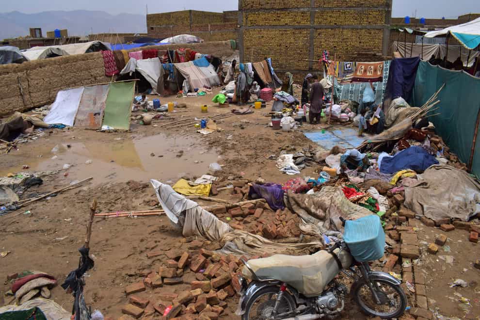 People salvage usable items from their house that was damaged by heavy rain, on the outskirts of Quetta (AP)