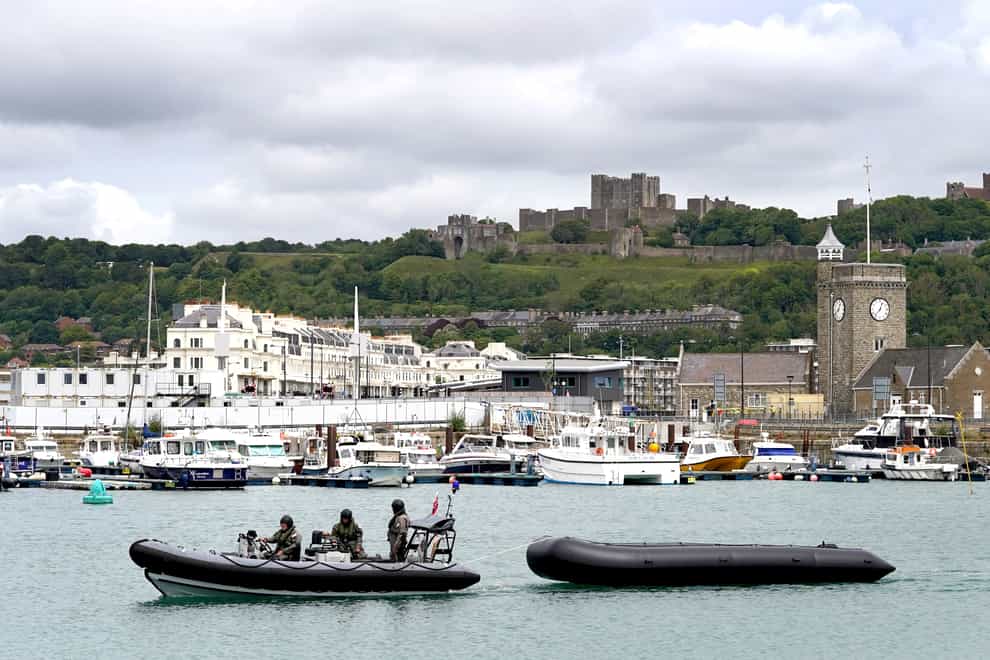 Military personnel tow a dinghy thought to be used by migrants in to Dover, Kent (Gareth Fuller/PA)