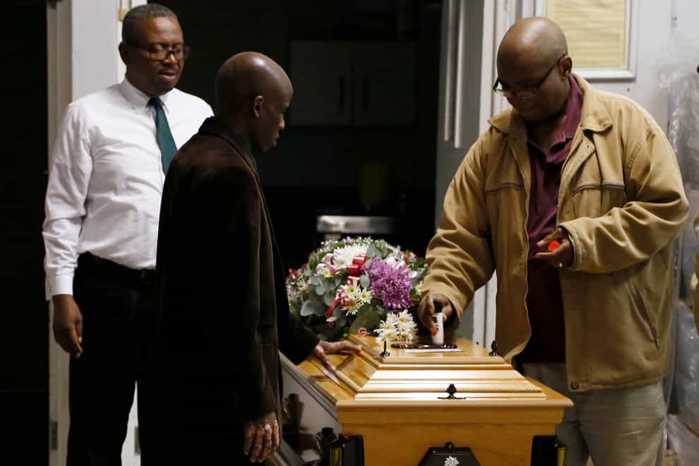 A coffin is prepared to be taken to a symbolic funeral in Scenery Park, East London (AP)