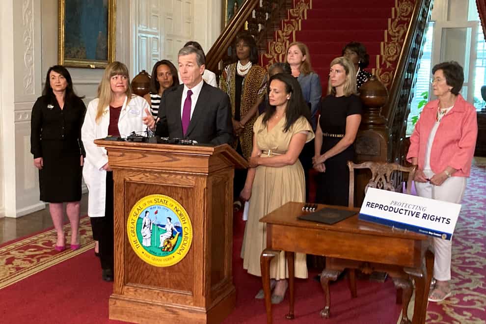 The Democratic governors of Colorado and North Carolina (Roy Cooper, shown) on Wednesday issued executive orders to protect abortion providers and patients from extradition to home states that have banned the practice (Gary D Robertson/AP)