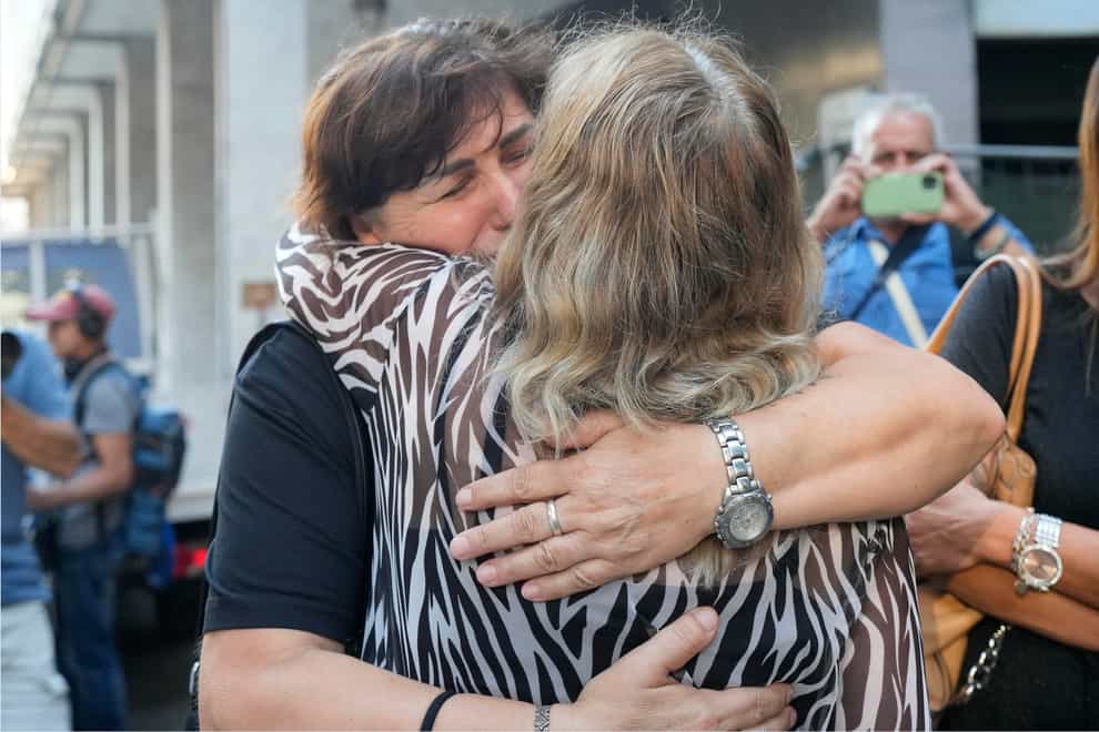 Two victims’ mothers embrace outside the court (Antonio Calanni/AP)