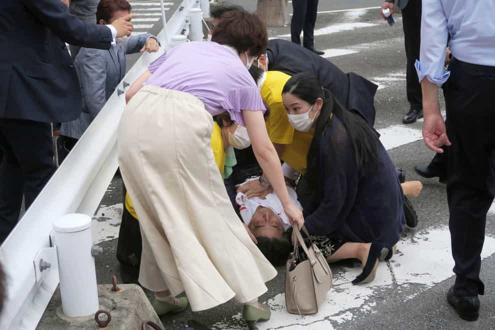 Japan’s former PM Shinzo Abe falls to the ground after the attack (Kyodo News via AP)