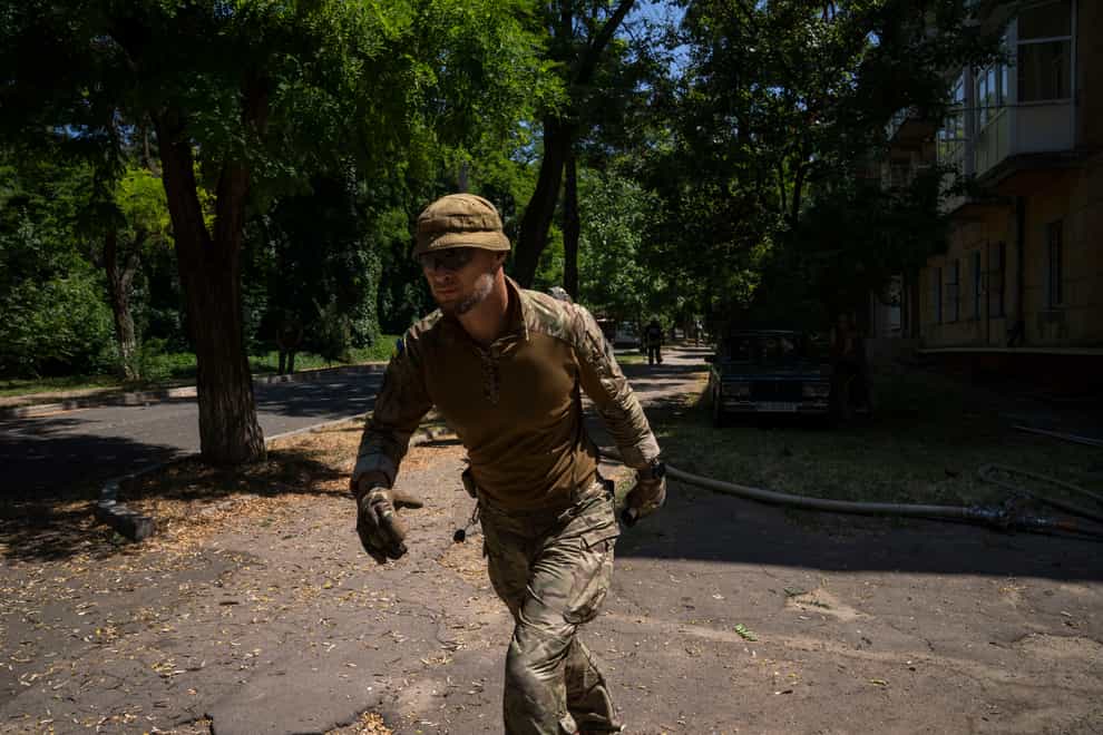 Ukrainian soldiers run after a strike hit a residential area in Kramatorsk, Donetsk region, eastern Ukraine (Nariman El-Mofty/AP)