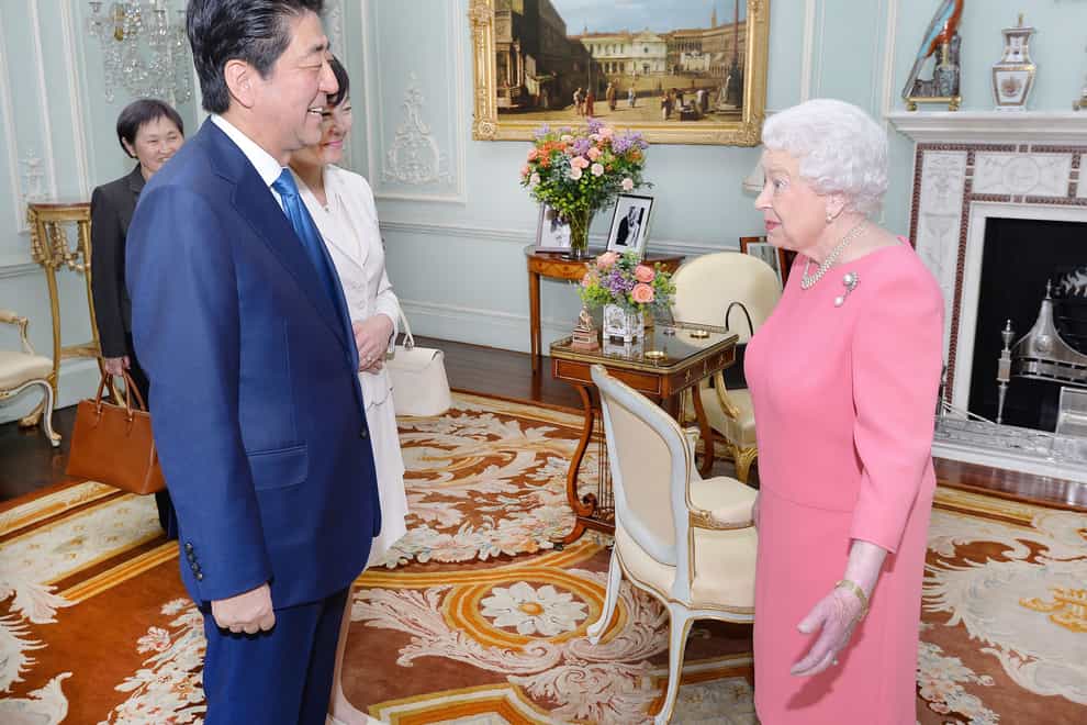 Queen Elizabeth II with former Prime Minister of Japan Shinzo Abe (PA)