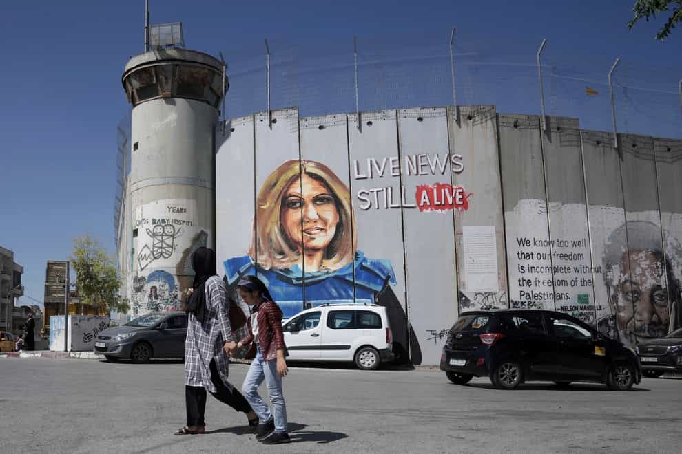 A mural depicting slain Palestinian-American journalist Shireen Abu Akleh adorns a part of Israel’s controversial separation barrier in the West Bank city of Bethlehem (Mahmoud Illean/AP)