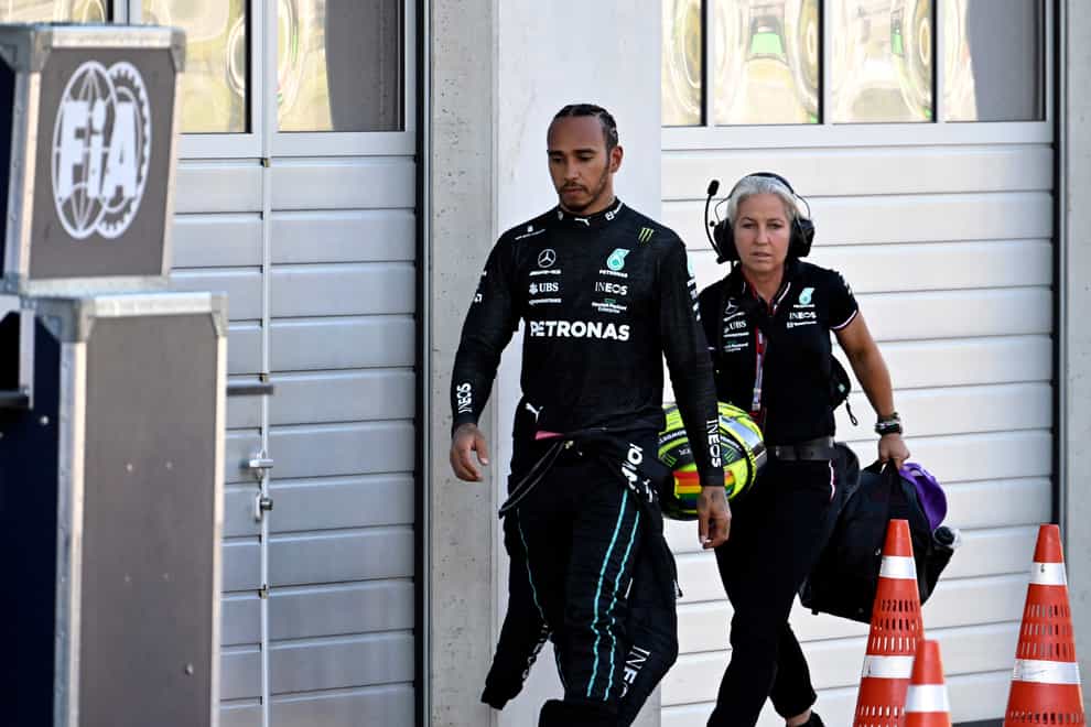 Mercedes driver Lewis Hamilton walks back to the pits after he crashed into the track wall during a qualifying session at the Red Bull Ring racetrack in Spielberg (Christian Bruna/Pool via AP)