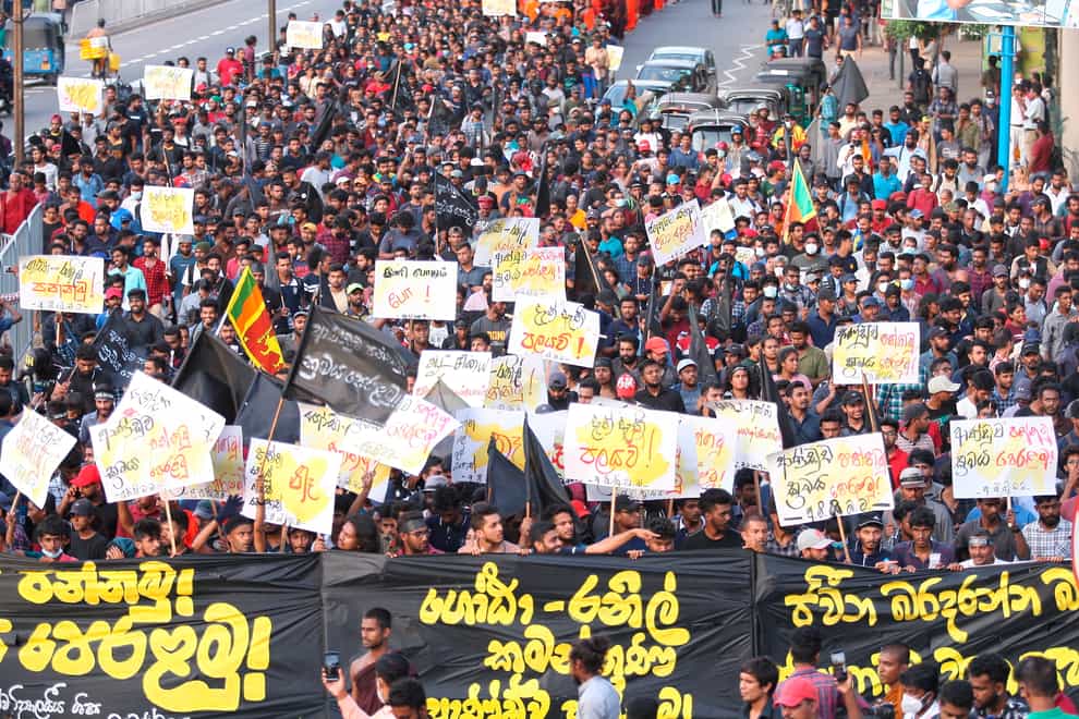 Protesters shout anti- government slogans during a march in Colombo, Sri Lanka (Amitha Thennakoon/AP)
