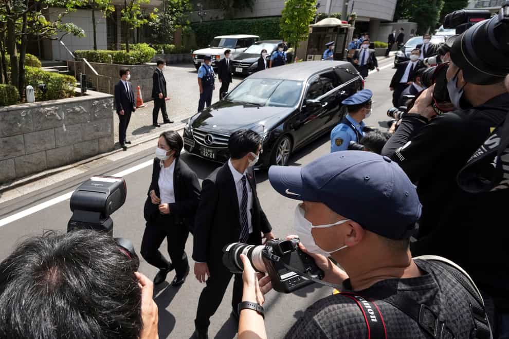 A car believed to be carrying the body of former Japanese PM Shinzo Abe arrives at his home in Tokyo (Eugene Hoshiko/AP)