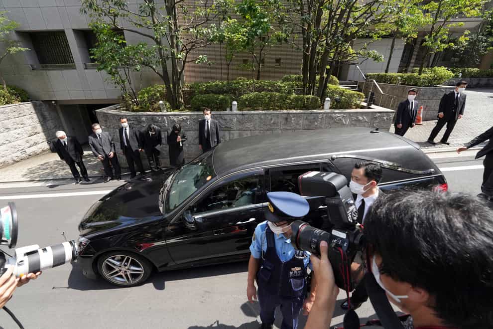 A car believed to carry the body of Japan’s former PM Shinzo Abe arrives at his home in Tokyo (Eugene Hoshiko/AP)