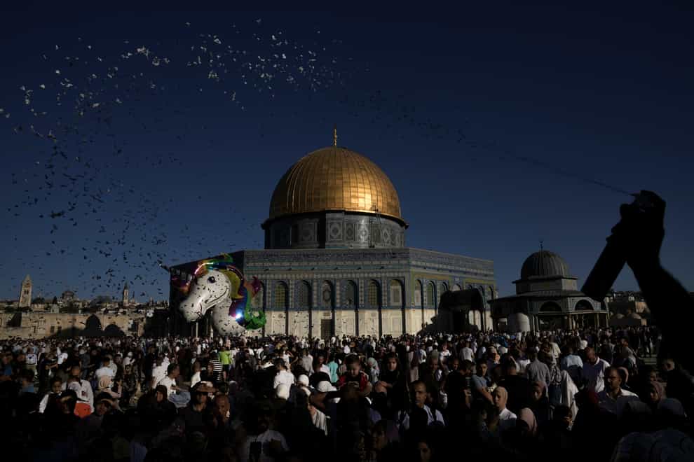 <p>Palestinians celebrate on the first day of Muslim holiday Eid al-Adha, at the Al Aqsa Mosque compound in Jerusalem’s Old City (Mahmoud Illean/AP)</p>