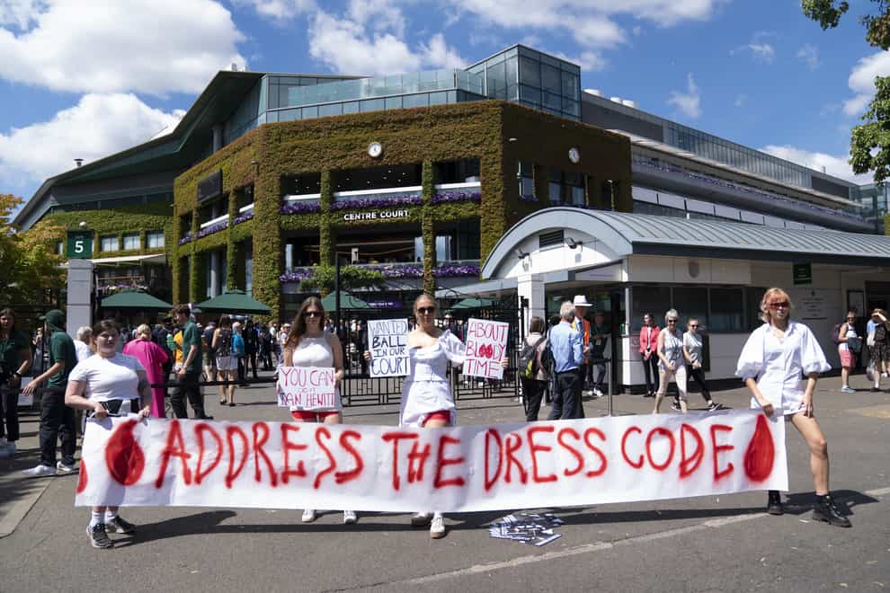 Campaigners from Address The Dress Code outside the main gate at Wimbledon protest over its all white dress code while women are on their period, on day thirteen of the 2022 Wimbledon Championships at the All England Lawn Tennis and Croquet Club, Wimbledon (Kirsty O’Connor/PA)
