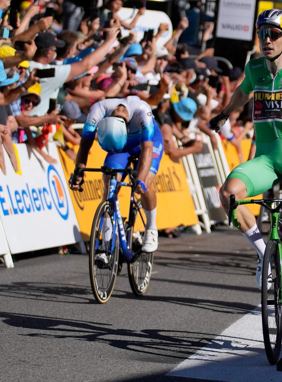 Wout Van Aert took the stage win while Tadej Pogacar was third to extend his lead in yellow (Thibault Camus/AP)