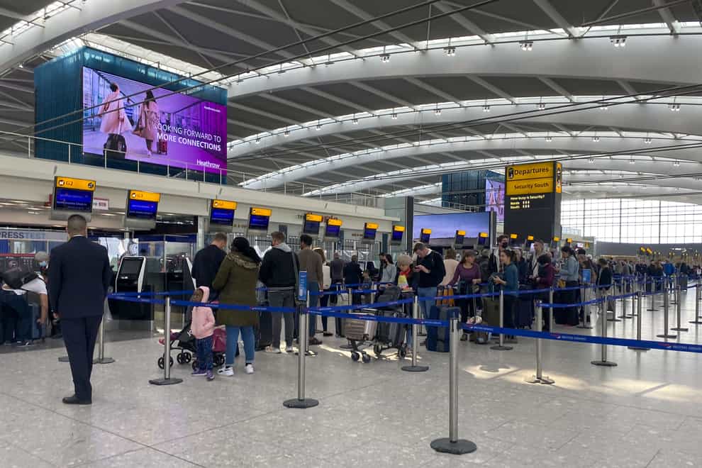 Passengers queue to check-in bags in departures at Terminal 5 of Heathrow Airport, west London (Steve Parsons/PA)