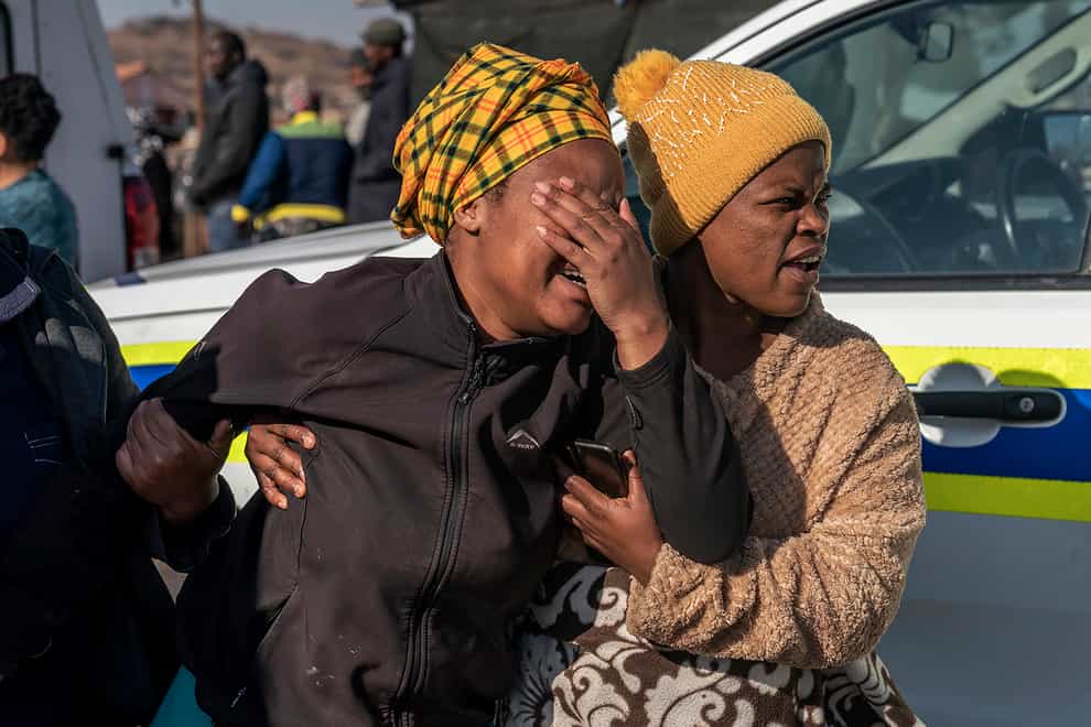 A woman weeps at the scene of a mass shooting in a bar in Soweto, South Africa (Shiraaz Mohamed/AP)
